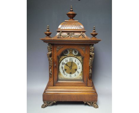 A LARGE EARLY 20TH CENTURY JUNGHANS CHIMING BRACKET CLOCK, the mahogany case with decorative carving and figural brass embell