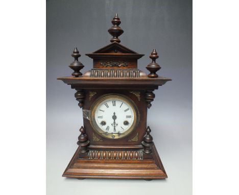 A JUNGHANS OAK CASED MANTLE CLOCK OF ARCHITECTURAL FORM, the enamel dial with Roman numerals, the 8 day movement striking on 