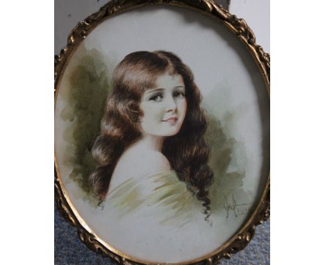 W.H. An oval portrait study of a young girl, signed with monogram and dated 1918 lower right, watercolour, framed and glazed,