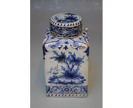 AN ANTIQUE DELFT TEA CANISTER AND LID, decorated with typical country scenes to all sides, marks to the base, H 14.5 cm  S/DC