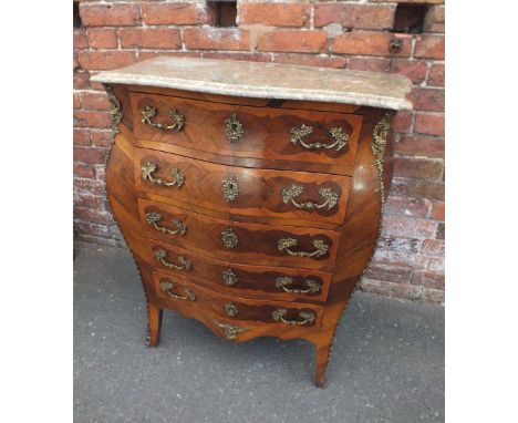 AN ANTIQUE MARBLE TOPPED BOMBE SHAPED COMMODE, the shaped stepped marble top above a range of five drawers, crossbanded and i
