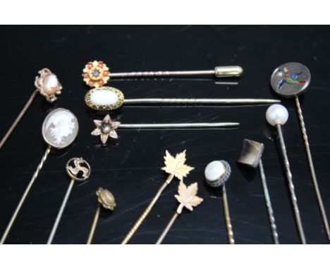 A COLLECTION OF VINTAGE STICK PINS, to include two cameo examples, gold examples including a 15ct floral style pin with centr