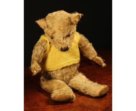 A 1930's jointed golden mohair teddy bear, replacement black boot button eyes, pronounced snout with vertically brown stitche