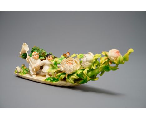 A Chinese polychrome ivory group of children hunting butterflies, first half 20th C. L.: 34 cm - H.: 8,5 cm We have more lots