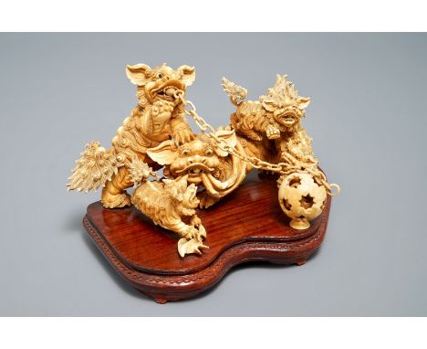 A Chinese carved ivory group of Buddhist lions playing with a ball, 19/20th C. L.: 28 cm - H.: 16,5 cm We have more lots avai