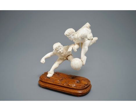 A rare Chinese carved ivory group of two boys playing football, 1st half 20th C. H.: 23,5 cm - L.: 20,5 cm We have more lots 