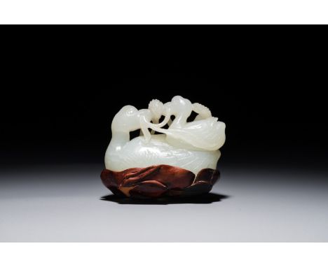A Chinese jade group of two Mandarin ducks on lotus leaf, 19th C. L.: 5,5 cm - H.: 4 cm (excl. base) We have more lots availa