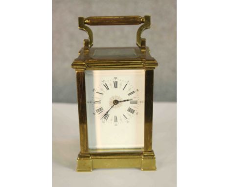 A late 19th/early 20th century brass cased carriage clock with white painted dial with black painted Roman and Arabic numeral