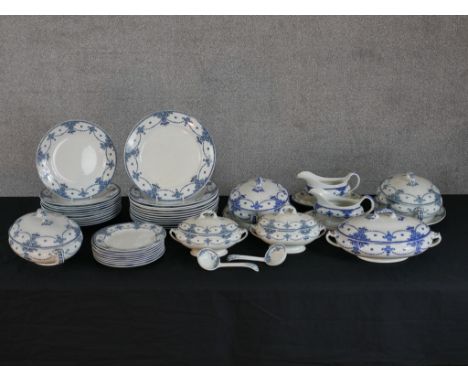 An early 20th century F. Winkle 'Carlton' part blue and white part dinner set, comprising of plates, sauceboats, lidded turee