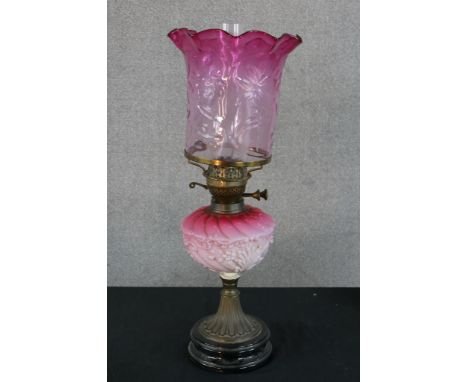 A late 19th century pink and white glass gilt metal oil lamp, raised on stepped circular base. H.45 W.20 D.20cm (quite unsecu