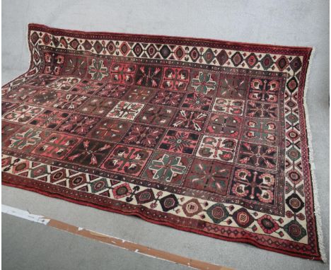 A large 20th century red ground Persian carpet with allover geometric tile pattern. L.218 W.310cm 