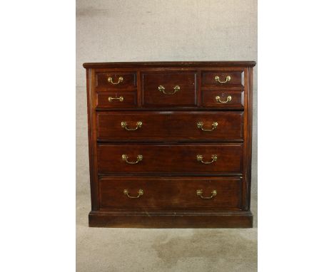 An Edwardian mahogany Scotch style chest of five short over three long graduating drawers with brass swing handles, raised on