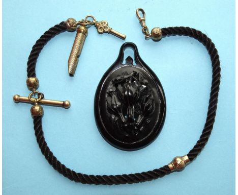 A 19th century plaited hair watch chain with plated mounts, whistle fob and watch key and a large jet pendant 75 x 50mm, (2).