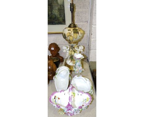 A late 19th century Moore Bros porcelain oil lamp, the compressed spherical reservoir and tree-trunk column applied with hops