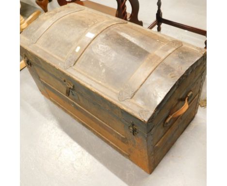 A dome toped oak bound travelling trunk.