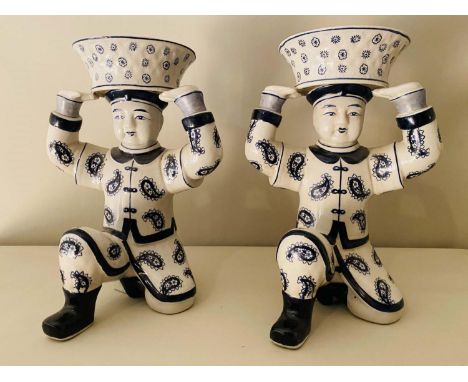 SERVING DISHES, a pair, in the form Chinese gentleman holding rice baskets moft, ceramic, 33cm x 23cm x 18cm. (2) 