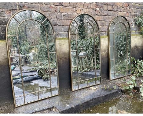ARCHITECTURAL GARDEN MIRRORS, a set of three, arched bronzed metal frames, 107cm x 55cm. (3) 