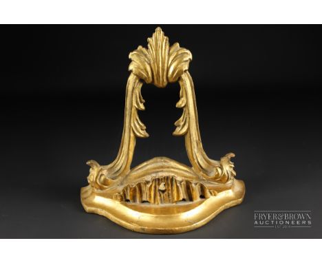 A gilded carved wood wall bracket, bowfront with foliate carved swag beneath, 18cm 