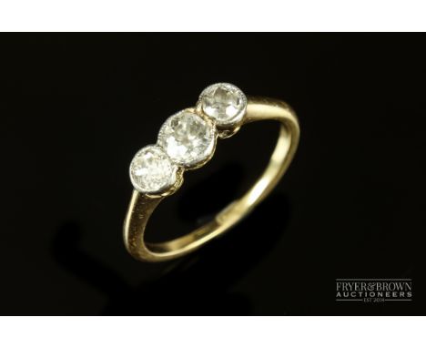 A diamond three stone diamond ring, c1920, millegrain set in platinum and 18ct yellow gold