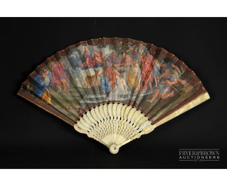 An early 18th century fan, the ivory sticks carved with figures, the guards with similar figures, mother of pearl detail to r