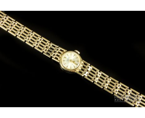 Rotary - a ladies 9ct yellow gold bracelet wristwatch, the circular dial on a gate link 9ct gold bracelet 
