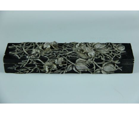 An unusual Oriental carved soapstone pen box probably 20th century, the elongated rectangular box finely carved with lily and