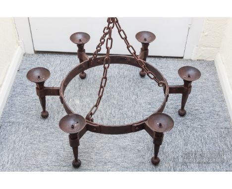 A wrought iron six-branch candle chandelier, circular, with three chain suspension, possibly 17th century, 74cm diameter max.