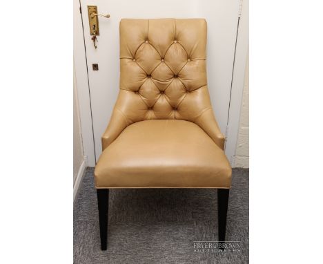 A button back chair upholstered in ochre leather, stud detailing to back, raised on tapering legs 