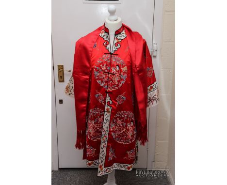 A Chinese embroidered red silk tunic, decorated in silver coloured wirework and coloured silks with figures in gardens; and a