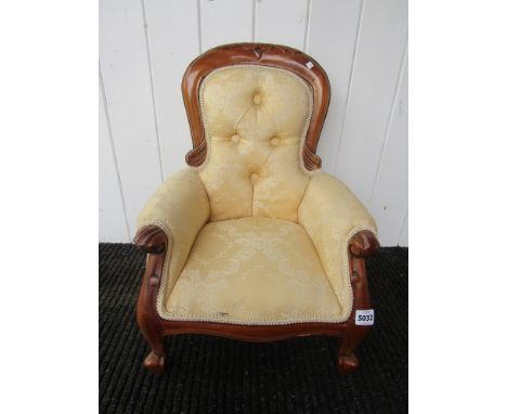 A Victorian style carved mahogany doll's chair in light gold floral button back upholstery