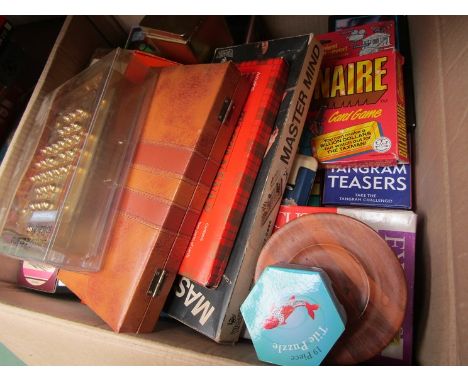 A large box of games and puzzles including Solitaire, Mastermind, Cribbage etc 