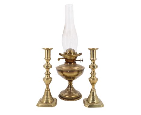 A pair of Victorian brass push-eject candlesticks together with a brass oil lamp, 47 cm tallest 