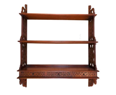A reproduction George III Chippendale style waterfall hanging bookshelf, having drawers to the base, 75 x 92 cm