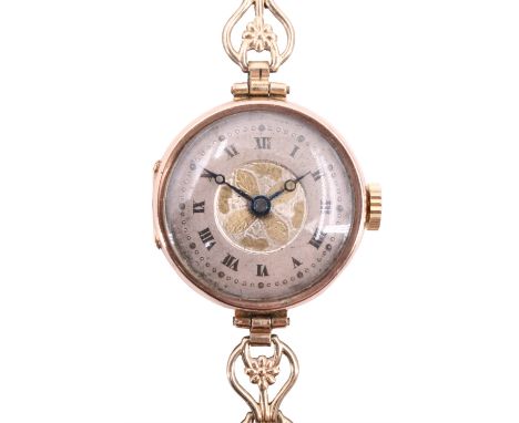 A George V 9 ct gold wristlet watch, having a Swiss movement and a two tone engine turned face, on a rolled gold bracelet, Gl