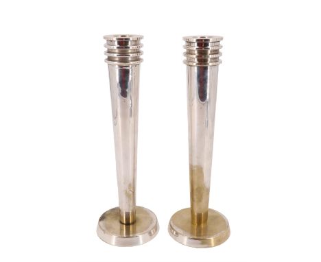A pair of Moderne / Art Deco style silver-plated candlesticks, of stark geometric form having tapering stems and circular fee