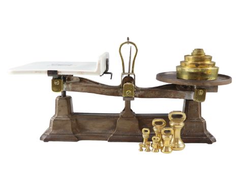 A set of late 19th / early 20th Century Avery cast iron and brass shop counter scales, having a white ceramic plate marked 'A