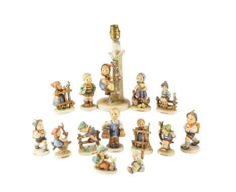 A quantity of Hummel figurines together with a Hummel table lamp, lamp 26 cm tall 