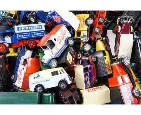A quantity of loose and boxed diecast vehicles, mostly vintage delivery wagons