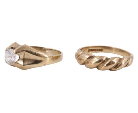 A 9 ct gold cabled finger ring and a white spinel solitaire ring, having a 0.5 carat brilliant set on adorsed fluted head in 