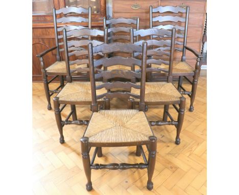 A quality set of six late 20th Century traditional rush-seated oak ladder back dining chairs, including two carvers, 95 cm hi