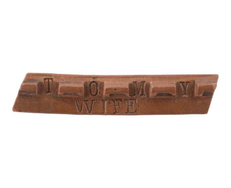 A Great War trench art sweetheart brooch comprising a fragment of an artillery shell copper driving badge letter-punched "To 