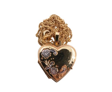 A 9 ct gold heart shaped double locket on fine curb link chain, having two tone engraved floral decoration, Birmingham, 1990,