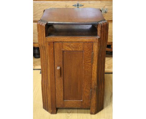 An Art Deco influenced oak bedside cabinet, circa 1940, 62 cm high