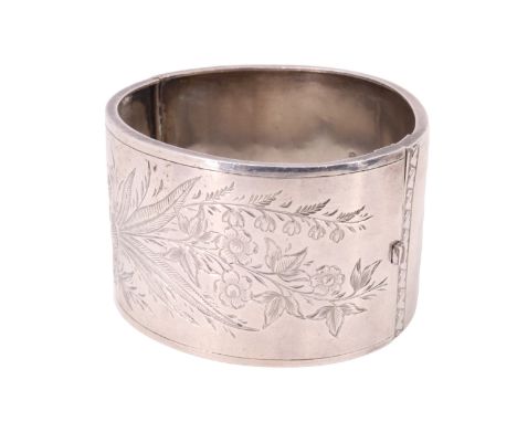 A Victorian silver bangle, decorated with engraved flora, James Fenton, Birmingham, 1885, 38 mm wide, 54  x 49 mm internally,
