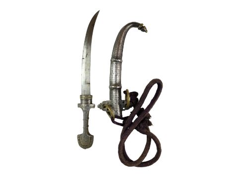 A Moroccan koumia dagger, decorated with hammered and engraved white metal foil (tested as silver) and enamel, 41 cm