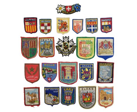 A collection of vintage travel / tourist fabric badges