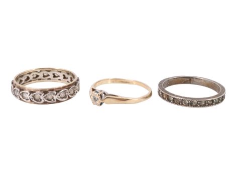 An illusion set diamond solitaire ring, the diamond set between open leaf shoulders in a 9 ct gold shank, together with a pre