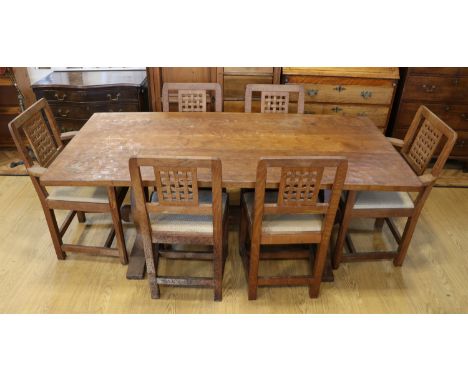 An adzed oak refectory dining table and six chairs by Derek 'Lizardman' Slater of Crayke, North Yorkshire[Derek Slater was ap