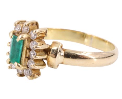 A late 20th Century emerald and white beryl finger ring, having an emerald baguette set on a conforming gallery above 12 surr