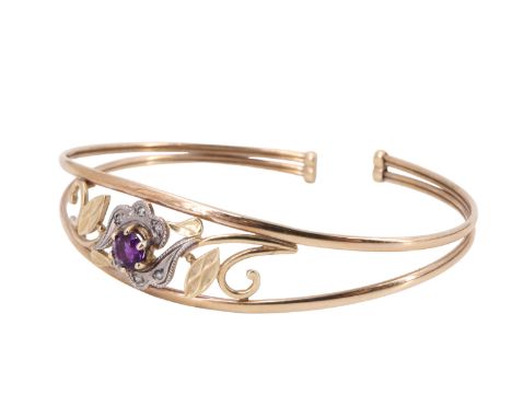 A contemporary amethyst and white stone set floral bangle, having a 5 mm amethyst brilliant surrounded by six small white sto